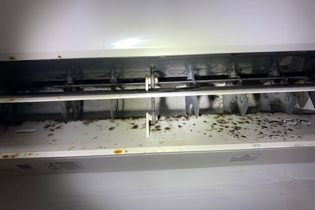 Black mould in air conditioner outlet vanes on a split system inspected by an air conditioning Gold Coast technician
