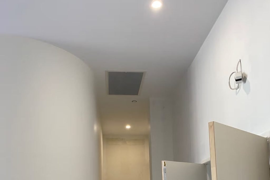 Ceiling access hatch used to reach roof ductwork when ducted air conditioning is not blowing air in one room