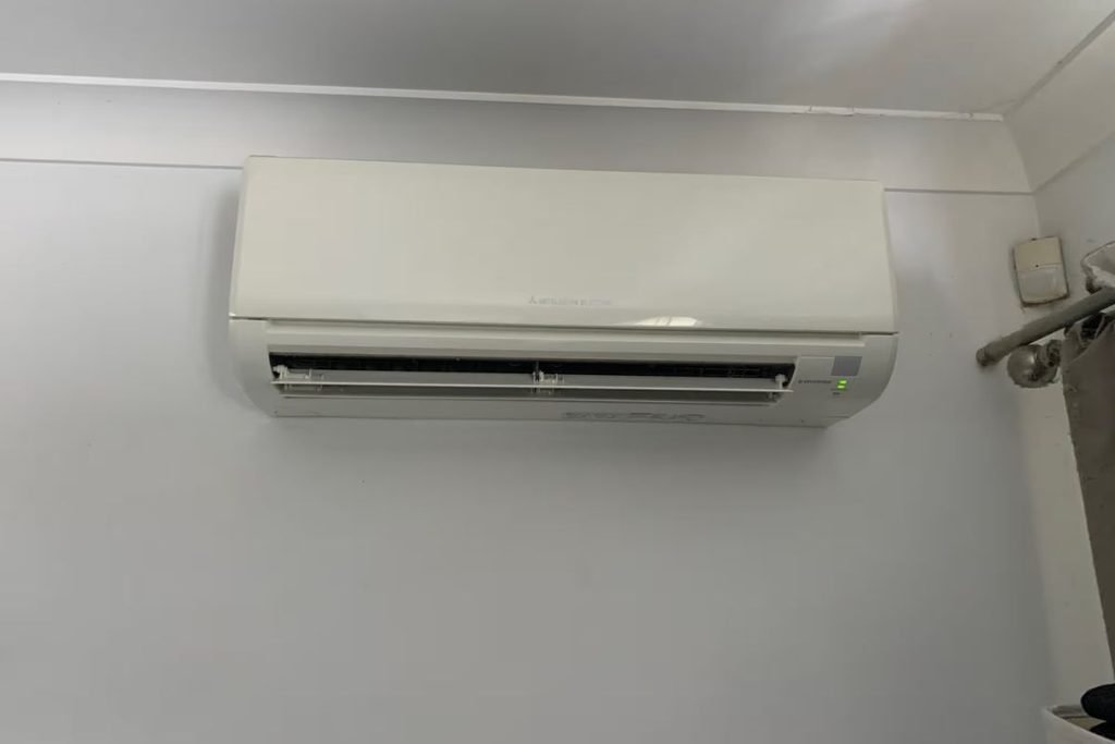 Mitsubishi Electric split system on a bedroom wall, checked for leaking water inside