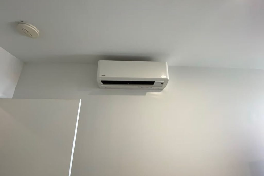 Toshiba split system mounted high on a wall, where an aircon leaking into wall can go unnoticed