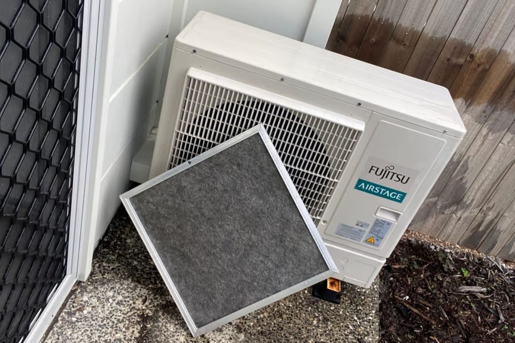 Dirty return air filter removed during ducted air conditioning maintenance on a Fujitsu Airstage system