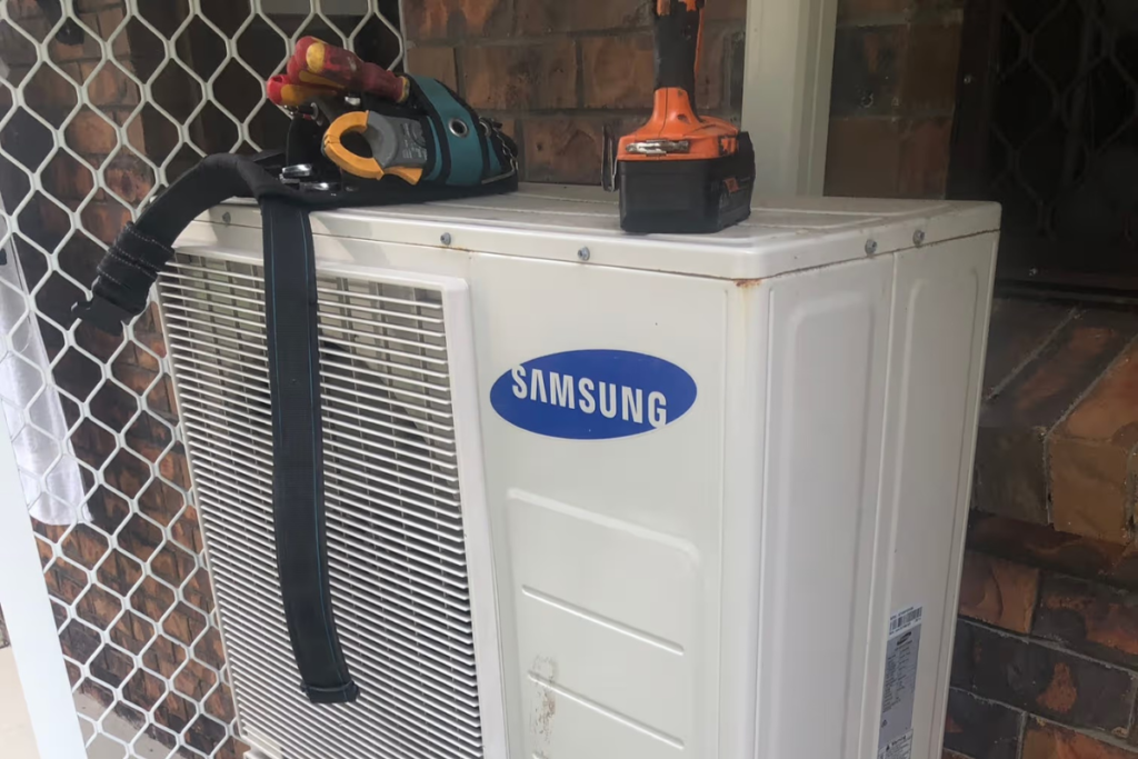 Technician tools on a Samsung outdoor unit during Samsung air conditioner repair